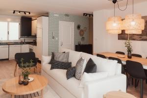 a living room with a white couch and a table at Mirando al sella in Arriondas