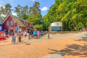a group of people walking around a street in a town at Dünenhaus Ückeritz UnserUsedomDe FeWo ca40qm mit Parkplatz direkt am Strand 3I2 in Ueckeritz
