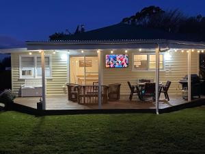 a house with a deck with a television on it at Beach Holiday Home-Close to Airport-3 Bed & 2 Bath in Lauderdale