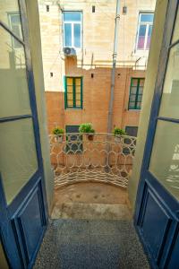 an open door of a building with a balcony at Duplex tastefully furnished flat in Valletta MCOP1-1 in Valletta