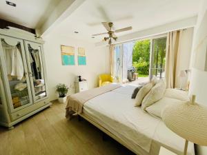 a bedroom with a large bed and a window at SuperHosts Suites Estepona in Estepona