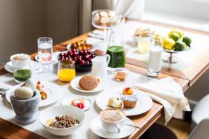 a table topped with plates of food and drinks at Grand Hotel Principe Di Piemonte in Viareggio