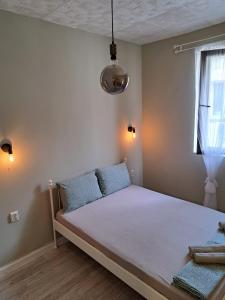 a bed in a room with a window at Magura Studios Plovdiv Center by Hancho Group in Plovdiv