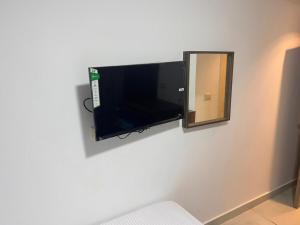 a flat screen tv on a wall next to a mirror at villa 17 in Cairo