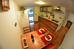 a kitchen and dining room with a table and a refrigerator at Apartment Arpa in Ljubljana