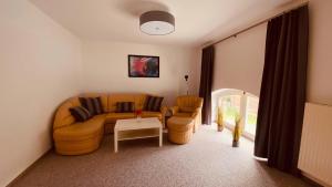a living room with a couch and two chairs at Ferienwohung An der Steinernen Kirche in Themar