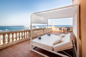 a balcony with a bed and a view of the ocean at Catalonia Majórica in Palma de Mallorca +42 photos