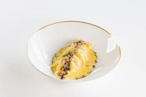 a white bowl with a dessert in it at Grand Hotel Principe Di Piemonte in Viareggio