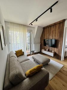 a living room with a couch and a flat screen tv at Apartman Green Divčigora in Divčibare