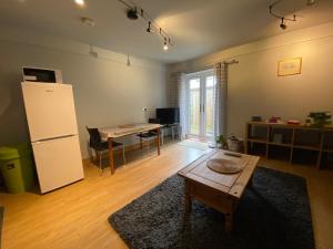 a living room with a table and a refrigerator at Host & Stay - Studley Knapp in Milton Keynes