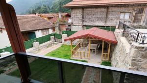 a view from the balcony of a building with a gazebo at Garden House Uzungöl in Uzungöl