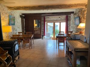 a kitchen and dining room with a table and chairs at Les Granges d'Ignaux in Ignaux