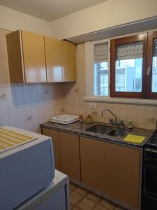 a kitchen with a sink and a counter top at Panoramico Playa Grande -Solo Familias in Mar del Plata