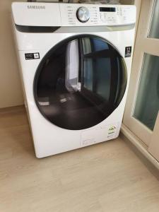 a white microwave sitting next to a window at Maru house Tranquil and Airy Space for Long or Short Stays in Nowon 2 qeen bed, near market, air-conditioner, Samsung TV in Seoul +7 photos