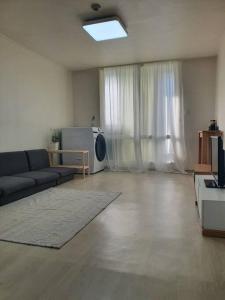 a living room with a couch and a tv at Maru house Tranquil and Airy Space for Long or Short Stays in Nowon 2 qeen bed, near market, air-conditioner, Samsung TV in Seoul