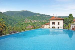 a swimming pool with a view of a mountain at Villa Oleandra by Quokka 360 - Private garden and swimming pool in Dizzasco +32 photos