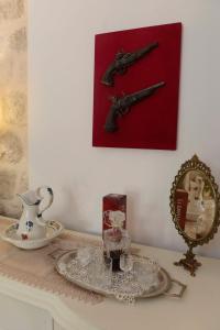 a table with a plate and a picture of a gun at Lazovic- Apartment by the Sea with Amazing View in Dobrota