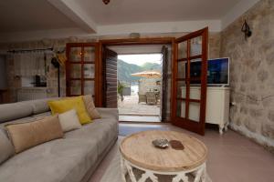 a living room with a couch and a table at Lazovic- Apartment by the Sea with Amazing View in Dobrota
