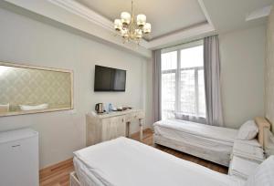 Postel nebo postele na pokoji v ubytování Homestay Hotel