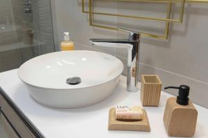 a white sink sitting on a counter in a bathroom at Lazovic- Apartment by the Sea with Amazing View in Dobrota +32 photos