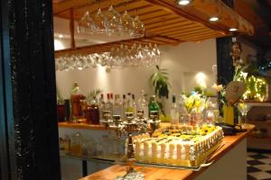 a table with a cake on a counter with wine glasses at ApartComplex New Tоwn in Obzor