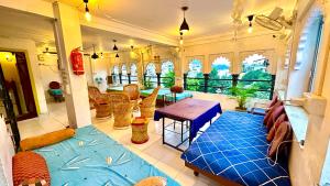 a living room with a couch and a table at Jungle by sturmfrei Udaipur in Udaipur