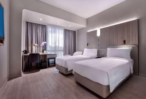 Postelja oz. postelje v sobi nastanitve Wyndham Singapore Hotel