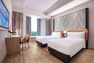 Postelja oz. postelje v sobi nastanitve Wyndham Singapore Hotel