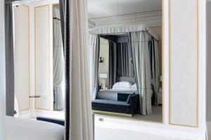 a mirror in a bedroom with a bed in it at Grand Hotel Principe Di Piemonte in Viareggio