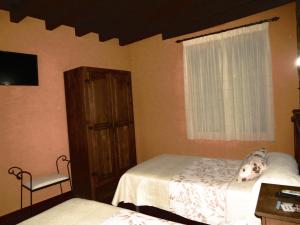A bed or beds in a room at El Rincon Del Villar
