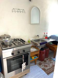 a kitchen with a stove and a sink at Hera guesthouse in Çorovodë +15 photos