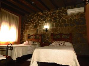 A bed or beds in a room at El Rincon Del Villar
