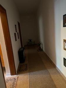 a hallway with a door and a television in a room at Hera guesthouse in Çorovodë