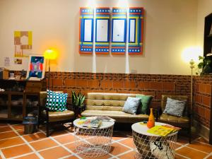 a living room with a couch and two chairs at Wuzou Guesthouse in Jinsha
