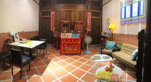 a living room with a couch and a table at Wuzou Guesthouse in Jinsha