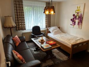 a room with a bed and a couch and a table at MAD Ferienwohnungen 2 in Dortmund