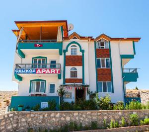 a building with a sign in front of it at Salda Gölü Çeliköz Apart in Yeşilova