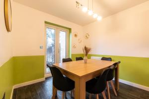 a dining room with a wooden table and chairs at Host & Stay - Moresby Way in Peterborough