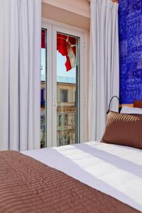 a bedroom with a bed and a large window at Airone Hotel in Naples