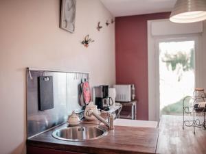 a kitchen with a sink and a counter top at Cottage near the Mill Pond with a beautiful garden in Le Ponchel