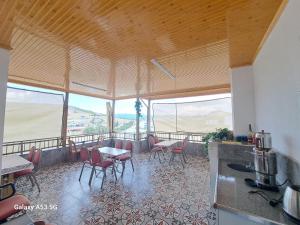 a room with tables and chairs on a balcony at Salda Gölü Çeliköz Apart in Yeşilova
