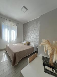 a bedroom with a bed in a white room at Le Tre Rose in Maratea