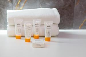a group of four bottles of sunscreen on a counter at Modern Apartment With Private Garden Międzywodzie by Renters Prestige in Międzywodzie