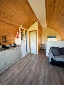 a large room with a bed and a kitchen at Welly Boot Pod in Shenstone