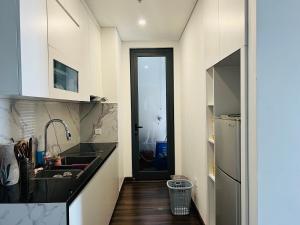 a kitchen with a sink and a refrigerator at Cosy homestay and apartment in Hai Phong