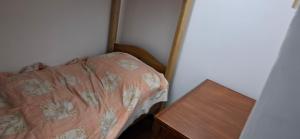 a small bedroom with a bed and a wooden table at Lowest Price Room In Chinatown Davao with WiFi Room 1 in Davao City