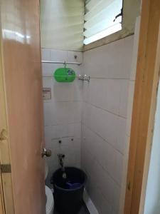 a small bathroom with a toilet and a window at Lowest Price Room In Chinatown Davao with WiFi Room 1 in Davao City