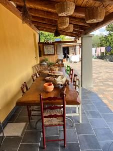 a wooden table and chairs on a patio at Al Vecchio Camino in Rotonda