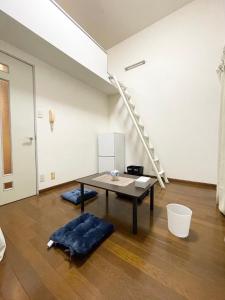 a living room with a table and a stair case at Pk唐人町 in Fukuoka +3 photos