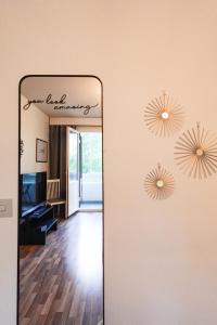 a mirror in front of a room with a mirror at Family Retreat Near Train and Kuusijärvi Lake in Vantaa